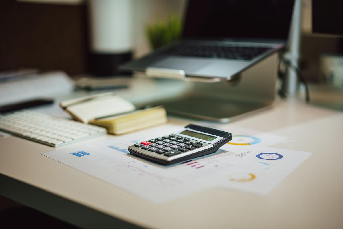 Calculator and notebook on a desk